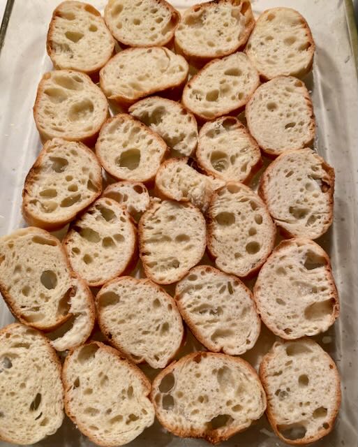 Bottom Layer of Bread Slices in Baking Dish for Basil Strata