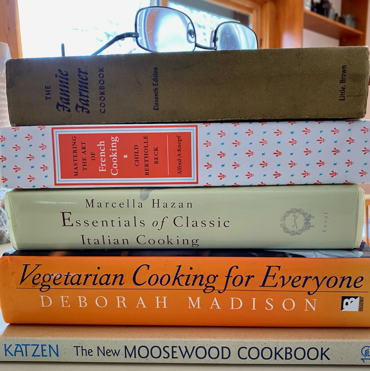 Stack of Cookbooks and Pair of Glasses