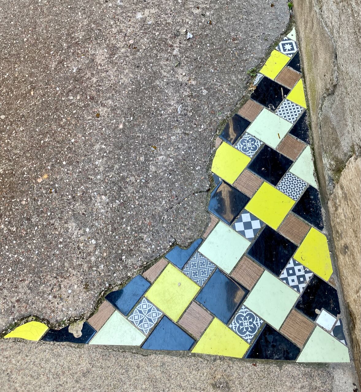 French Sidewalk Mosaic with Yellow, Black, and Blue Tiles