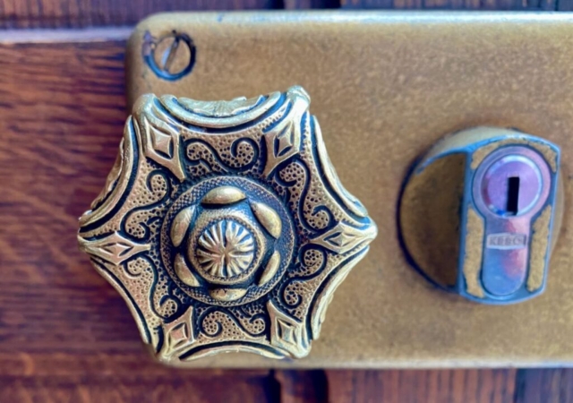 Six-Sided Detailed Parisian Door Knob on a Wood Door