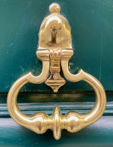 Gold Parisian Door Knocker on a Green Door