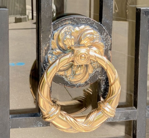 Wreath-Shaped Parisian Door Knocker Mounted on an Iron Gate