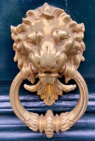 Ornate Gold Lion Parisian Door Knocker on a Blue Door