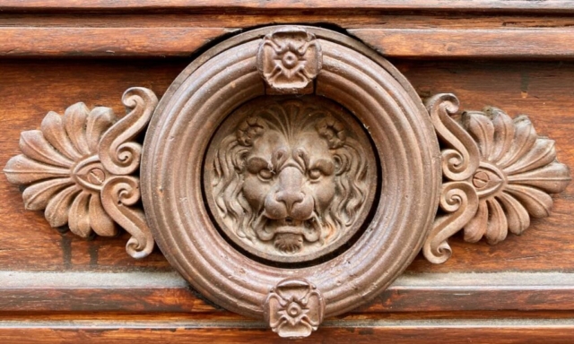 Parisian Door Knocker with a Lion Center on a Wood Door