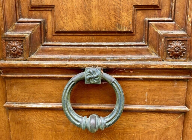 Brass Parisian Door Knocker with Green Patina on a Wood Door