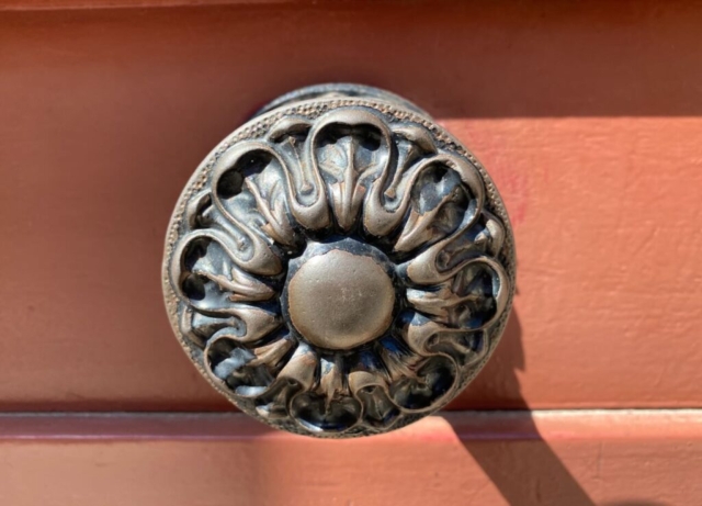 Worn Parisian Door Knob On a Brown Door