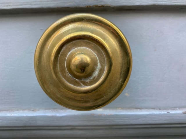 Round Parisian Door Knob on a Gray Door