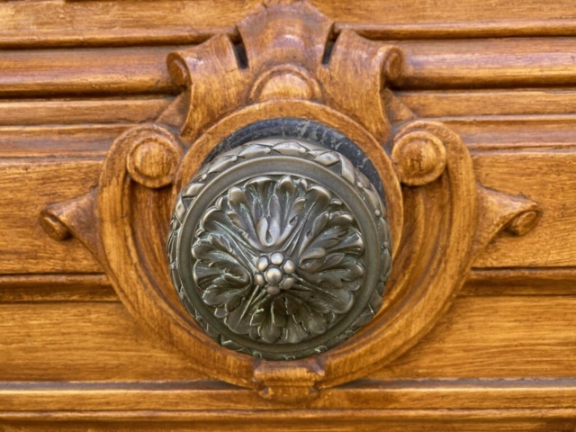 Parisian Door Knob with Flower Design on a Wood Door