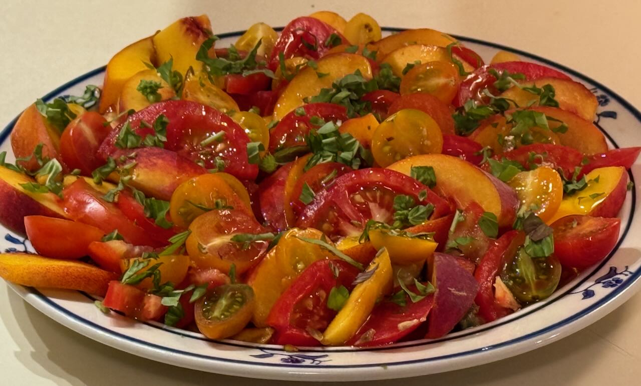 Plate of Tomatoes and Peaches Garnished with Olive Oil and Basil